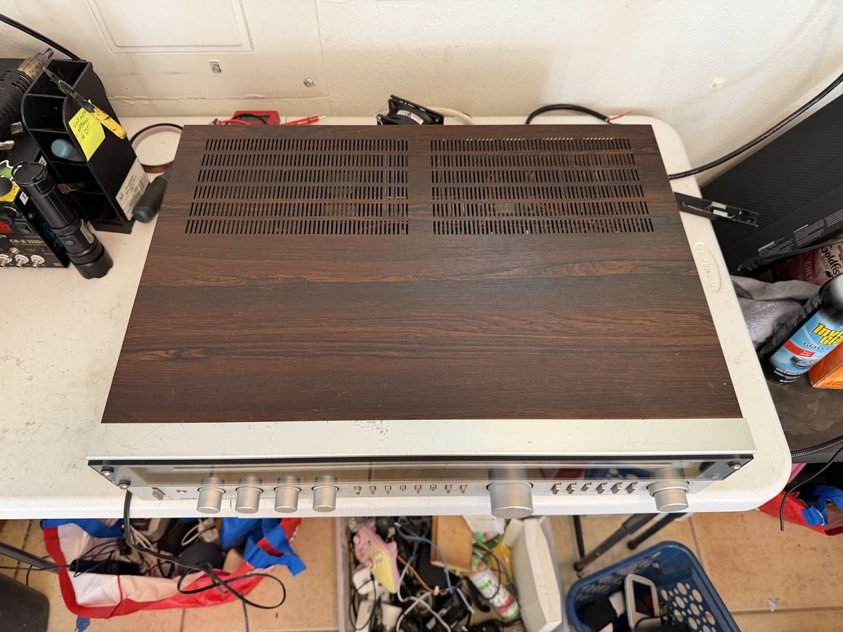Wood-cased vintage tuner amplifier face down on the Tomasetti Tech Repair bench